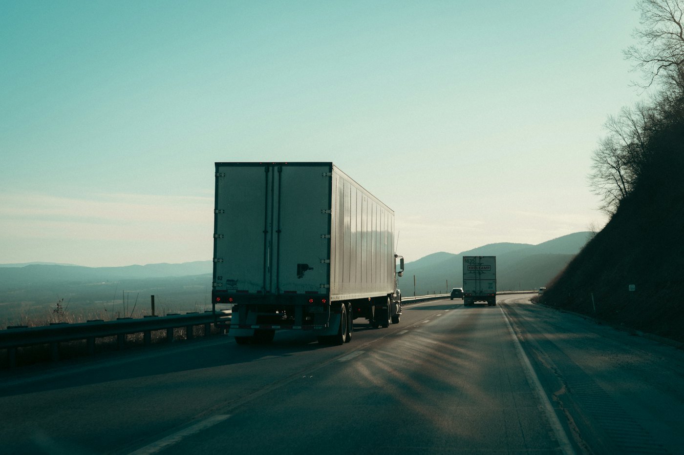 Truck trailers travelling a highway through hills